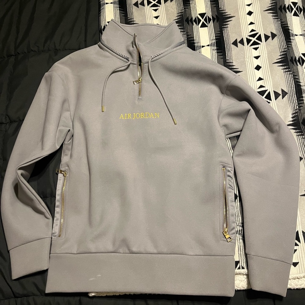 Brand new never worn grey and gold air Jordan half zip jacket .